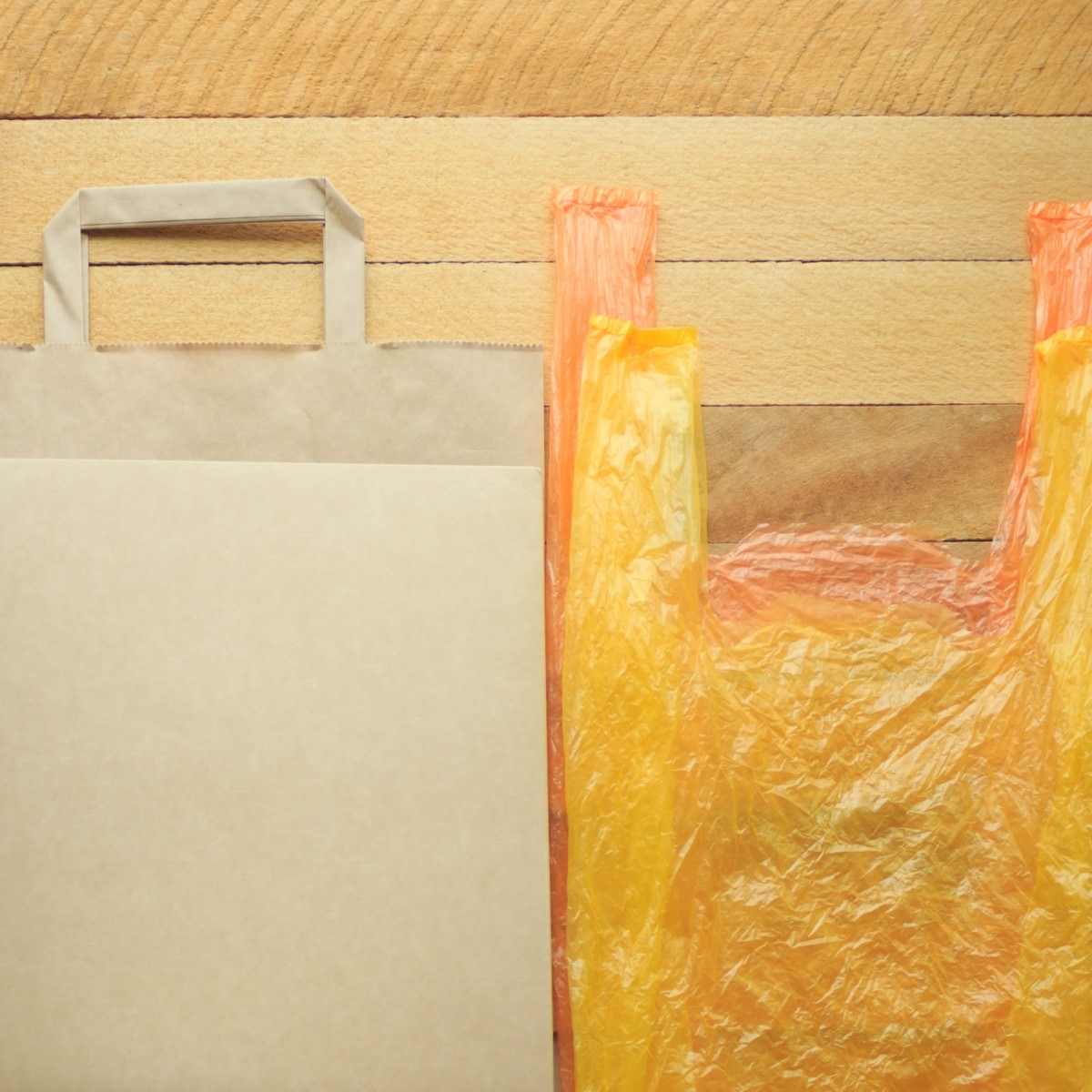 Two plastic bags on a wooden table.