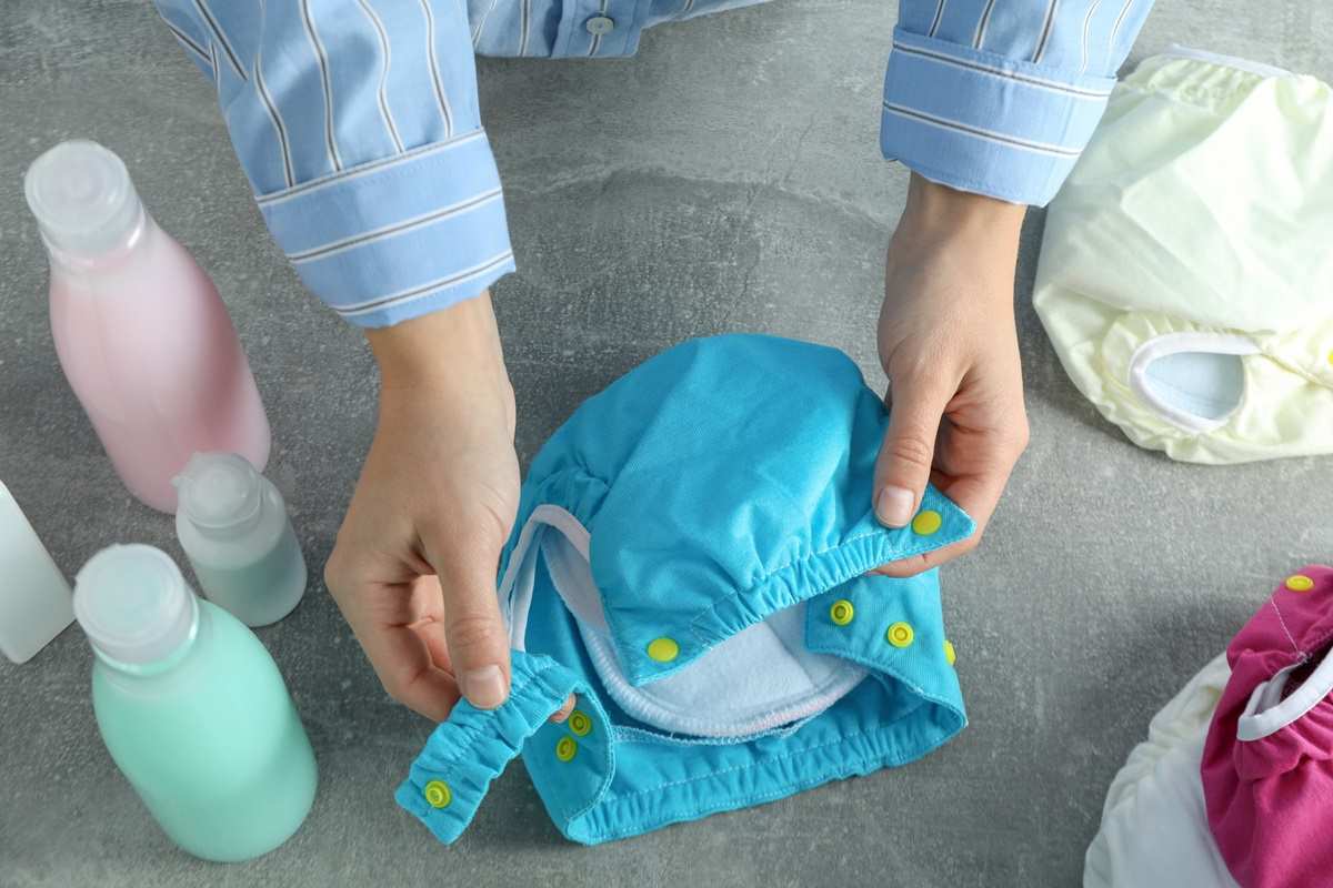 Holding a blue cloth diaper.