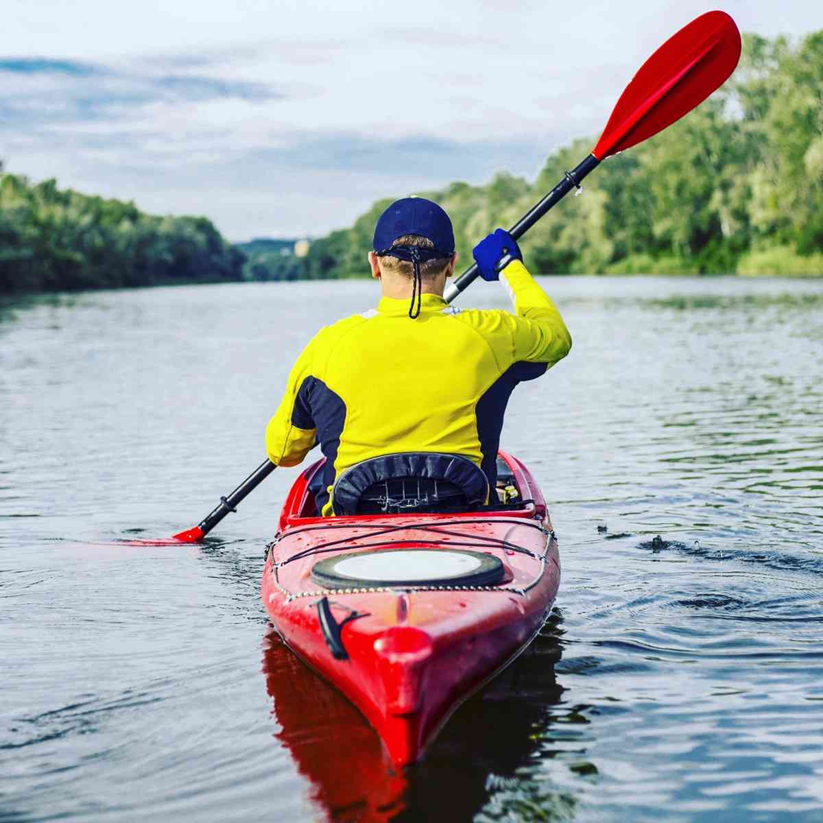 Person kayaking on a river.